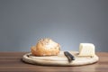 Wholemeal bread roll with caraway seeds, butter, knife Royalty Free Stock Photo