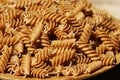 Wholemeal Fusilli in a plate. Integral Pasta over a wooden table