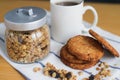 Wholemeal oatmeal cookies stack with granola and coffee on napkin