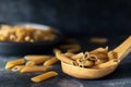 Wholemeal pasta over wooden spoon dark food