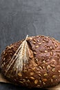 Wholemeal rye bread with sunflower and pumpkin seeds on black stone background Royalty Free Stock Photo