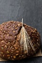 Wholemeal rye bread with sunflower and pumpkin seeds on black stone background Royalty Free Stock Photo