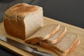 Wholemeal sliced bread on a bamboo chopping board. Royalty Free Stock Photo