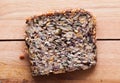 Wholemeal, wholewheat slice of bread on wooden table. Organic, healthy food Royalty Free Stock Photo