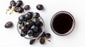 Wholesome Delights: A Captivating Display of Black Grapes and Grape Molasses on a Crisp White Backdr