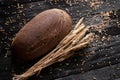 Wholesome and hearty bread is lying on a wooden table. One loaf Royalty Free Stock Photo