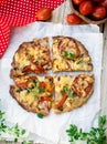 Wholewheat pizza with tomatoes, cheese and herbs