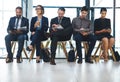 Wholl be called in first. Full length shot of a diverse group of businesspeople sitting in line for an interview in a Royalty Free Stock Photo