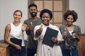 Whos the best You are. Portrait of a group of young businesspeople showing thumbs in a modern office. Royalty Free Stock Photo