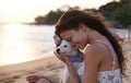 Whos a good boy. an attractive young woman petting her dog at the beach. Royalty Free Stock Photo