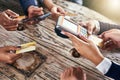 Whos paying first. High angle shot of a group of businesspeople paying their bills with credit cards while being seated