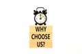 Why choose us symbol. Concept word Why choose us on beautiful wooden block. Black alarm clock. Beautiful white table white Royalty Free Stock Photo