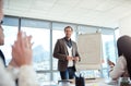 This is why hes our team leader. businesspeople applauding during a presentation in an office. Royalty Free Stock Photo