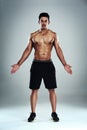 This is why I workout. Full length portrait of a sporty young man standing against a grey background. Royalty Free Stock Photo