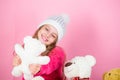 Why kids love stuffed animals. Toy every child dreaming. Kid little girl play with soft toy teddy bear on pink Royalty Free Stock Photo