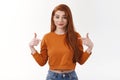 Why not pick me. Cute stylish urban young redhead sassy woman long red haircut pointing herself cetner copy space