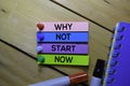 Why Not Start Now text on sticky notes isolated on the tables Royalty Free Stock Photo