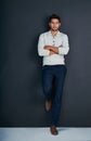 Why so serious. Studio shot of a handsome young man against a dark background. Royalty Free Stock Photo