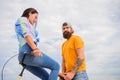 Why women more attracted biker guys. Girl sit on handlebar of his bike. Man bearded hipster rides girlfriend on his bike
