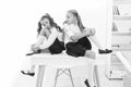 Why are you sad. School club. Little schoolgirls classmates friendly kids. Schoolgirls friends sit on desk. Best friends Royalty Free Stock Photo