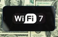 Wi-Fi 7 generation background, icon close-up. Mobile phone supporting Wi-Fi technology, business photo