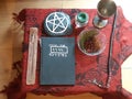 Wiccan altar, fall altar setup, pagan magic ritual altar design. Book of shadows, wand, incense and candles