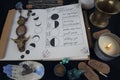 Book of Shadows with lunar phases on black altar. Royalty Free Stock Photo