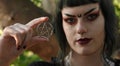 A Wiccan teen girl holds up a pentagram, symbol of her belief.