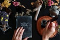 Wiccan witch casting ready to write down a spell in her Book of Shadows Grimoire Royalty Free Stock Photo