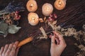 Wiccan witch decorating a DIY besom broom for Samhain celebration Royalty Free Stock Photo