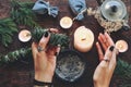 Wiccan witch holding cedar cleansing stick to cleanse the energy at her altar Royalty Free Stock Photo