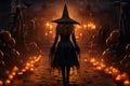 Wicked witch in Halloween, pumpkin head Jack-lantern candles burning with fire. Royalty Free Stock Photo