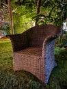 Wicker armchair on a garden at night