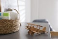 Wicker basket with accessories and airplane on grey table in child room