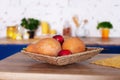 Wicker basket with apples and pumpkins in kitchen. Fresh vegetables on kitchen background. Fruits and vegetables in wicker straw d Royalty Free Stock Photo