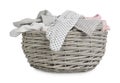 Wicker basket with baby clothes isolated on white Royalty Free Stock Photo