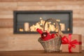 Wicker basket with bottle of wine and gift boxes on table in room Royalty Free Stock Photo