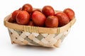 Wicker basket with cherry tomatoes mini kumakos cut in half and whole. With drops of water. Royalty Free Stock Photo