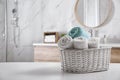 Wicker basket with clean soft towels in bathroom. Space for text Royalty Free Stock Photo