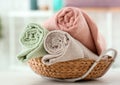 Wicker basket with clean soft towels on white table Royalty Free Stock Photo