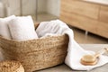 Wicker basket with clean towels and massage brush in bathroom Royalty Free Stock Photo