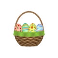 Wicker basket with colorful Easter eggs