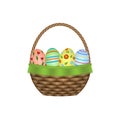 Wicker basket with colorful Easter eggs Royalty Free Stock Photo