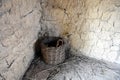 Wicker basket in the corner of an old hut made of wicker, clay and mud. Royalty Free Stock Photo