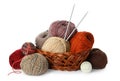 Wicker basket with different balls of woolen knitting yarns and needles on white background Royalty Free Stock Photo