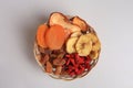 Wicker basket with different dried fruits on white background, top view Royalty Free Stock Photo