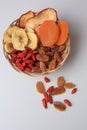 Wicker basket with different dried fruits on white background, top view Royalty Free Stock Photo