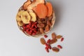 Wicker basket with different dried fruits on white background, top view Royalty Free Stock Photo