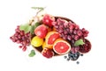 Wicker basket with different fruits and berries on white background, top view Royalty Free Stock Photo