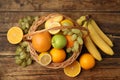 Wicker basket with different fruits on wooden table, flat lay Royalty Free Stock Photo